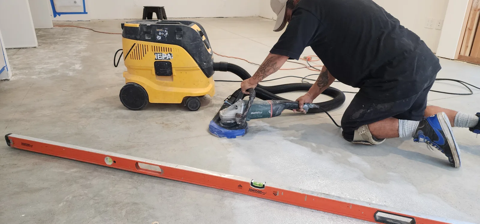 Grinding a concrete subfloor flat before a new floor goes down
