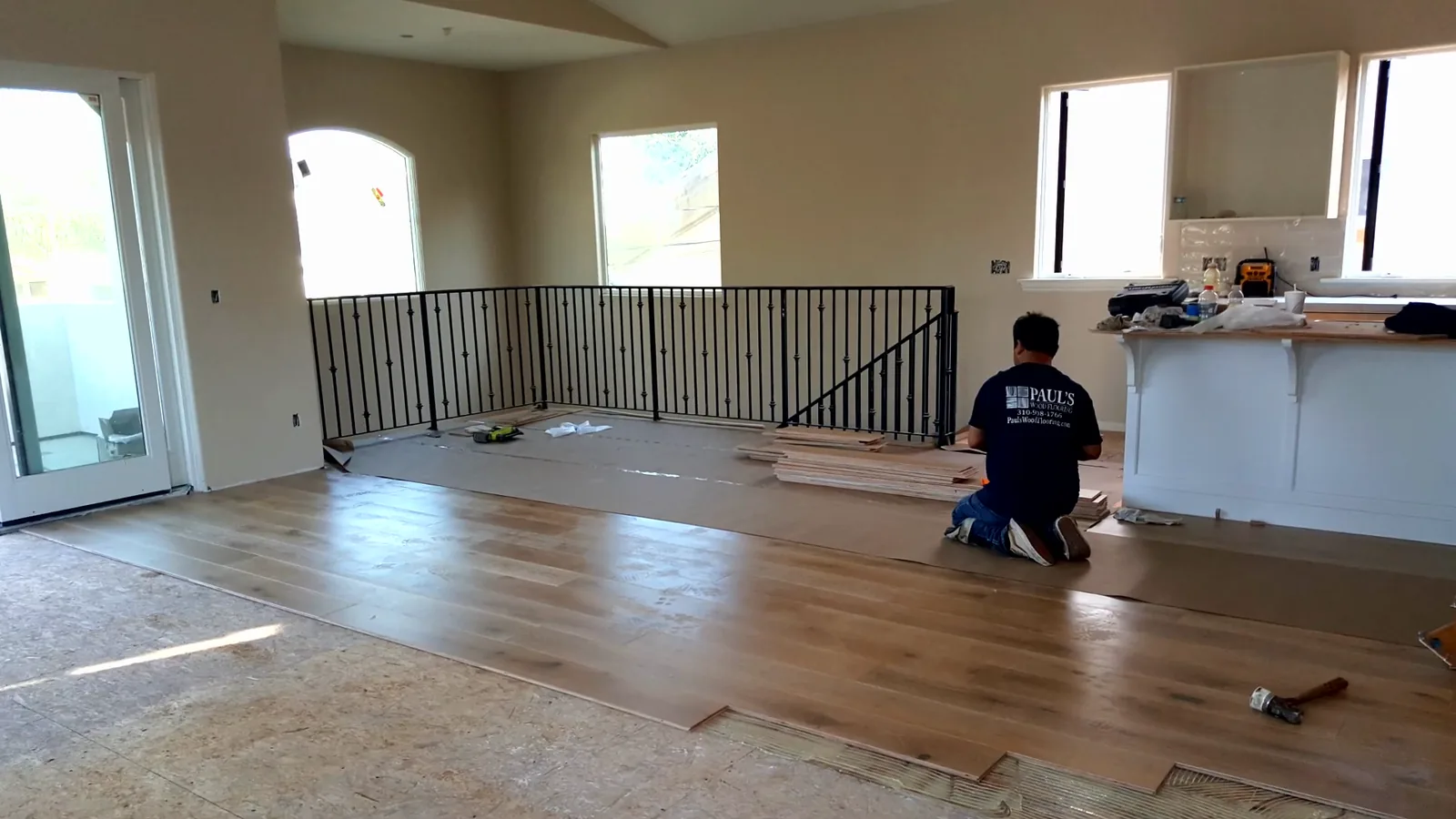 Crew installing planks in a great room